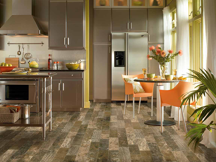 Eclectic styled kitchen that has porcelain tile wood-look flooring in varying colours
