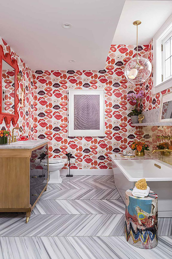Striped tile pattern in bathroom with bright pink patterned wallpaper  