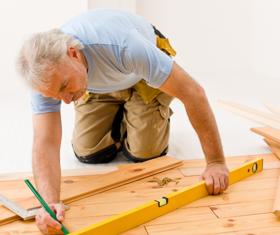 Contractor measuring hardwood flooring