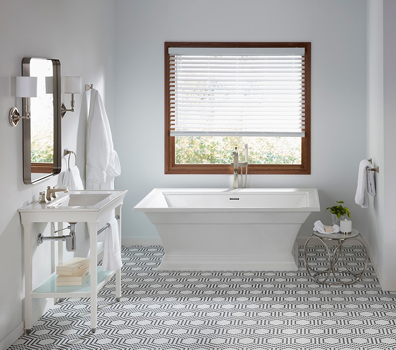 classic fixture light colored bathroom with patterned tile floor