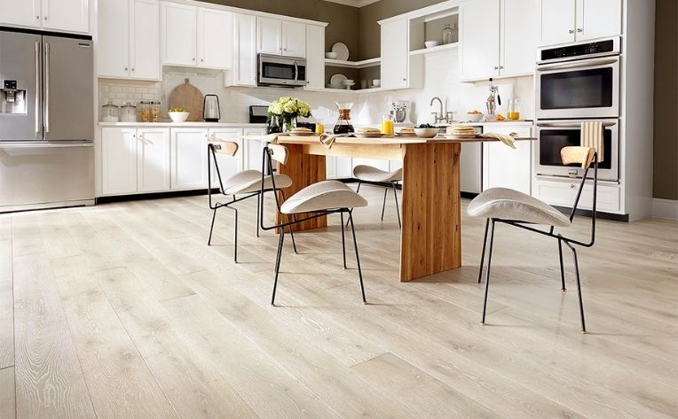 Light wood floors in a kitchen.