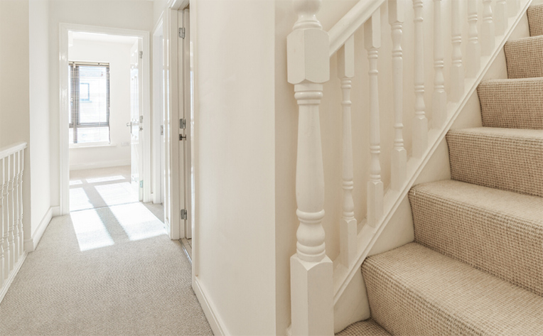 Beautiful beige carpet in the upstairs hallway and stairs leading to the third level