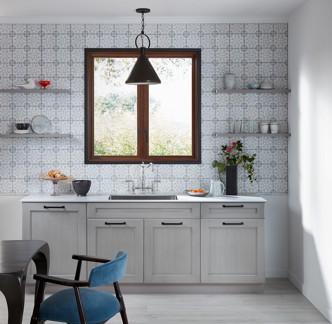 kitchen sink and counter with patterned backsplash