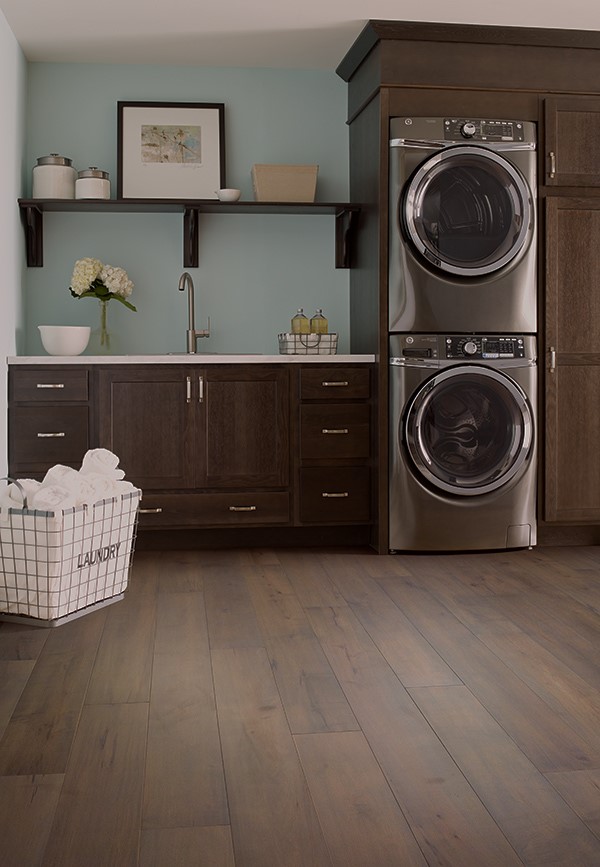 waterproof hardwood in laundry room with stacked appliances